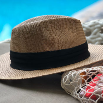 beige-and-black-hat-near-swimming-pool-984619