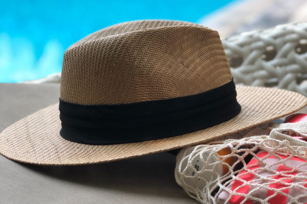beige-and-black-hat-near-swimming-pool-984619